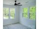 This bedroom features lots of natural light and large windows overlooking a yard at 1413 Hateras Ave, Charlotte, NC 28216