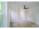 A bright bedroom featuring light gray floors and a ceiling fan at 1413 Hateras Ave, Charlotte, NC 28216