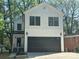 Charming two-story home with modern black garage door, neutral color, and eye catching design at 1413 Hateras Ave, Charlotte, NC 28216