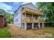 Rear exterior view highlighting the three-story layout and wooden decks at 1413 Hateras Ave, Charlotte, NC 28216