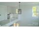 Bright, open floor plan featuring modern chandelier and natural light from large windows at 1413 Hateras Ave, Charlotte, NC 28216