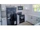 Modern kitchen with black appliances, white cabinetry and quartz countertops at 1413 Hateras Ave, Charlotte, NC 28216