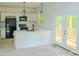 Bright and modern kitchen featuring an island with quartz countertops and a door to the deck at 1413 Hateras Ave, Charlotte, NC 28216