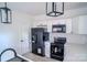 Well-lit kitchen boasts modern black appliances, white cabinets, and quartz countertops at 1413 Hateras Ave, Charlotte, NC 28216