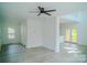 Spacious living room boasts a ceiling fan and leads to the kitchen and outdoor deck at 1413 Hateras Ave, Charlotte, NC 28216