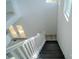 Modern staircase with hardwood steps and white railings, leading to a bright landing at 1413 Hateras Ave, Charlotte, NC 28216