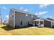 Side view of backyard showing the covered patio and outdoor grill area at 14224 Canemeadow Dr, Charlotte, NC 28278