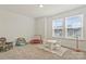 Bonus room featuring two windows, table and chairs, a play set, a toddler trampoline, and carpeted floor at 14224 Canemeadow Dr, Charlotte, NC 28278