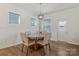Bright dining area with a round table, upholstered chairs, and modern pendant lighting at 14224 Canemeadow Dr, Charlotte, NC 28278