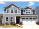 Charming two-story home with a well-maintained lawn and a two-car garage at 14224 Canemeadow Dr, Charlotte, NC 28278