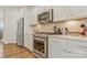 Close-up of the kitchen featuring stainless steel appliances and subway tile backsplash at 14224 Canemeadow Dr, Charlotte, NC 28278