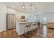 Open kitchen with stainless steel appliances, a large island, and sleek white cabinetry at 14224 Canemeadow Dr, Charlotte, NC 28278