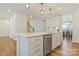 Spacious kitchen features a large island, stainless steel dishwasher and modern white cabinets at 14224 Canemeadow Dr, Charlotte, NC 28278