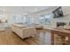 Bright living room with a fireplace, large sofa, hardwood floors, and natural light from the many windows at 14224 Canemeadow Dr, Charlotte, NC 28278