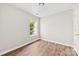 Bright bedroom featuring wood floors, a large window, and fresh paint creates a calming and inviting retreat at 1682 Sandpiper Dr, Rock Hill, SC 29732