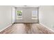 Bright bedroom featuring two windows, wood-look flooring, and neutral wall color at 1682 Sandpiper Dr, Rock Hill, SC 29732