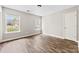 Bright bedroom featuring two windows, wood-look flooring, and neutral wall color at 1682 Sandpiper Dr, Rock Hill, SC 29732