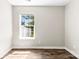 Bright bedroom featuring a window and wood-look flooring, and neutral wall color at 1682 Sandpiper Dr, Rock Hill, SC 29732