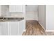 Bright kitchen featuring granite counters and modern white cabinetry leading into the living room at 1682 Sandpiper Dr, Rock Hill, SC 29732