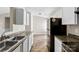 Updated kitchen features stainless appliances, granite counters, and modern white cabinetry for a sleek cooking experience at 1682 Sandpiper Dr, Rock Hill, SC 29732
