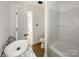 Well-lit bathroom showcasing a sink, toilet, and tub with white walls and flooring at 171 Three Cs Rd, Kershaw, SC 29067