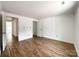 Large room with wood floors, white walls, and multiple doorways, offering versatile space at 171 Three Cs Rd, Kershaw, SC 29067