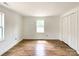 Spacious bedroom with hardwood floors, large windows, and a closet creating a welcoming atmosphere at 171 Three Cs Rd, Kershaw, SC 29067
