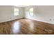 Bedroom with dual windows for lots of natural light and wood-look flooring at 171 Three Cs Rd, Kershaw, SC 29067
