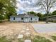 Charming single-story home with light blue siding and a walkway of stepping stones to the front door at 171 Three Cs Rd, Kershaw, SC 29067