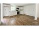 Bright, open-concept kitchen with white cabinets, stone countertops, and stainless steel appliances at 171 Three Cs Rd, Kershaw, SC 29067