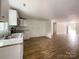 Open concept living room and kitchen with wood-look flooring and white walls at 171 Three Cs Rd, Kershaw, SC 29067
