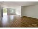 Large living room with wood-look flooring, white walls and natural light at 171 Three Cs Rd, Kershaw, SC 29067