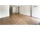 Bright, open-concept living space with wood-look floors leading to the entry door at 171 Three Cs Rd, Kershaw, SC 29067