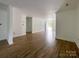 Bright, open-concept living space with wood-look floors leading to the entry door at 171 Three Cs Rd, Kershaw, SC 29067