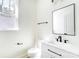 A bright, tidy bathroom showcasing a white sink vanity, black hardware, and a clean aesthetic at 176 Forest Creek Dr, Statesville, NC 28625