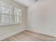 An empty bedroom featuring light walls, baseboards, a double window, and wood-look flooring at 176 Forest Creek Dr, Statesville, NC 28625