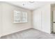 Well-lit bedroom features plush gray carpeting, a large window, and a closet for ample storage at 176 Forest Creek Dr, Statesville, NC 28625