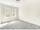 Bright bedroom with a large window featuring a woodside view at 176 Forest Creek Dr, Statesville, NC 28625