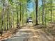 Long gravel driveway leading to a secluded home surrounded by trees, offering privacy and a peaceful retreat at 176 Forest Creek Dr, Statesville, NC 28625