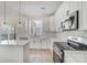 A newly remodeled kitchen featuring stainless steel appliances, white cabinets, an island, and a window view at 176 Forest Creek Dr, Statesville, NC 28625