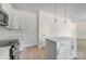 A bright kitchen boasting white cabinetry, stainless appliances, a kitchen island, and modern pendant lighting at 176 Forest Creek Dr, Statesville, NC 28625