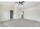 Spacious main bedroom with a ceiling fan and view of the en suite bathroom at 176 Forest Creek Dr, Statesville, NC 28625