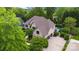 Aerial view of a home with a pool and manicured landscaping in a verdant, upscale neighborhood at 18618 Rollingdale Ln, Davidson, NC 28036