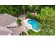 Overhead shot of home with in-ground pool, patio, and landscaped fire pit surrounded by lush trees at 18618 Rollingdale Ln, Davidson, NC 28036