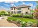 Backyard featuring a brick house, patio, and lush landscaping at 18618 Rollingdale Ln, Davidson, NC 28036