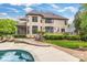 Backyard featuring a pool, brick home, patio, and lush landscaping at 18618 Rollingdale Ln, Davidson, NC 28036