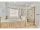 Bathroom featuring a soaking tub with tile surround and glass-enclosed shower at 18618 Rollingdale Ln, Davidson, NC 28036