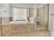 Luxurious bathroom featuring a soaking tub and a separate glass-enclosed shower at 18618 Rollingdale Ln, Davidson, NC 28036
