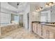 Luxurious bathroom with a double vanity, soaking tub, and glass-enclosed shower at 18618 Rollingdale Ln, Davidson, NC 28036