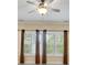 Bedroom featuring large windows with natural light and a ceiling fan for added comfort at 18618 Rollingdale Ln, Davidson, NC 28036